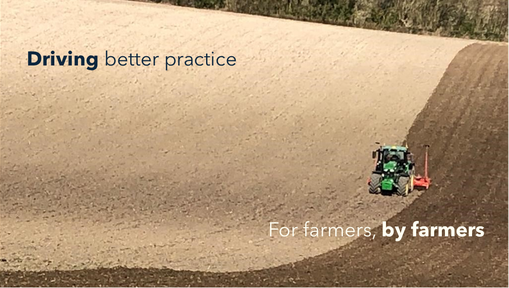 A tractor drilling spring barley, undersown with grass, on contour-ploughed land to avoid erosion.